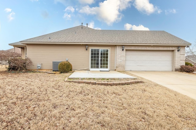 rear view of house featuring central AC and a garage