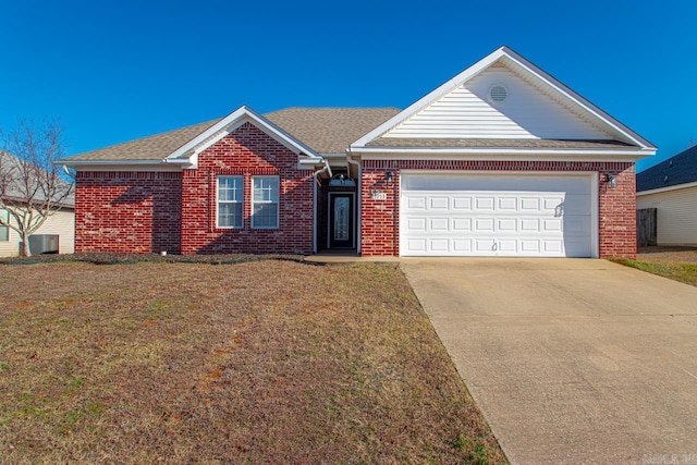 view of front of house featuring central AC unit, a front yard, and a garage