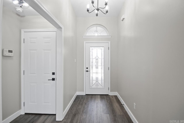 foyer entrance featuring a chandelier and dark hardwood / wood-style flooring