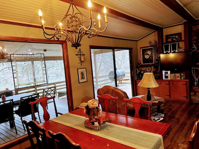 dining area featuring beam ceiling, an inviting chandelier, ornamental molding, and wood-type flooring