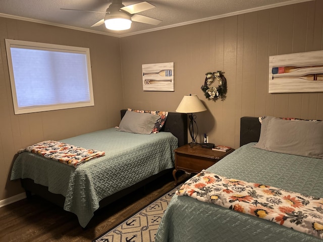 bedroom with ornamental molding, dark hardwood / wood-style floors, and ceiling fan