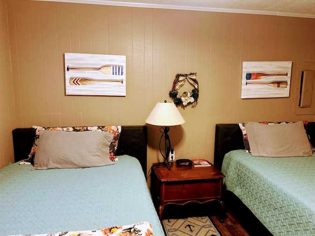 bedroom featuring ornamental molding and wood-type flooring