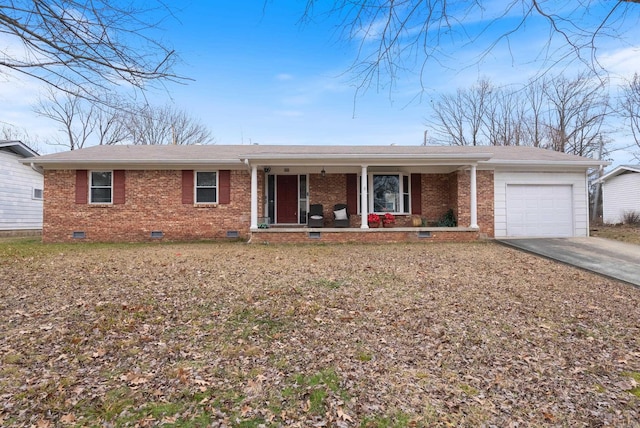 ranch-style home featuring covered porch and a garage