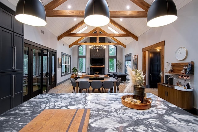 dining space with beam ceiling, french doors, high vaulted ceiling, and wooden ceiling