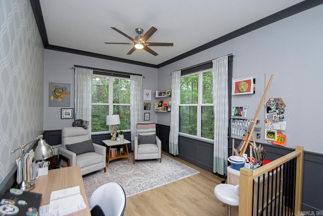 living room featuring ceiling fan, light hardwood / wood-style floors, and ornamental molding