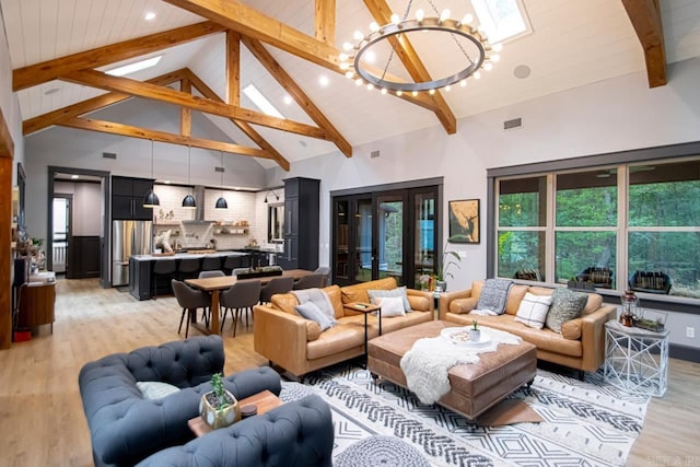 living room with beam ceiling, light hardwood / wood-style flooring, high vaulted ceiling, and a chandelier