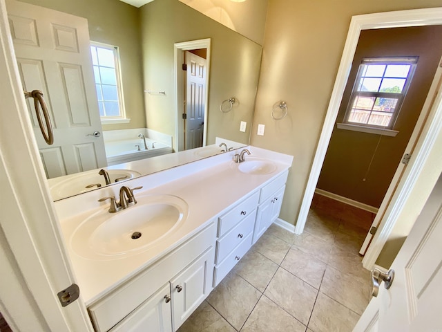 bathroom with tile patterned floors, vanity, and a tub to relax in