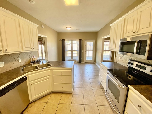 kitchen featuring white cabinets, light tile patterned flooring, sink, and stainless steel appliances