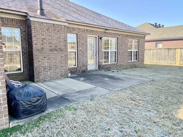 rear view of house featuring a yard and a patio area