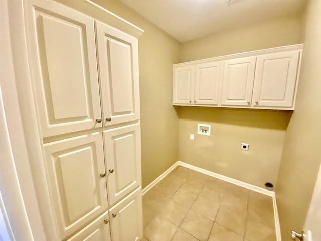 laundry area featuring hookup for an electric dryer, washer hookup, cabinets, and light tile patterned flooring