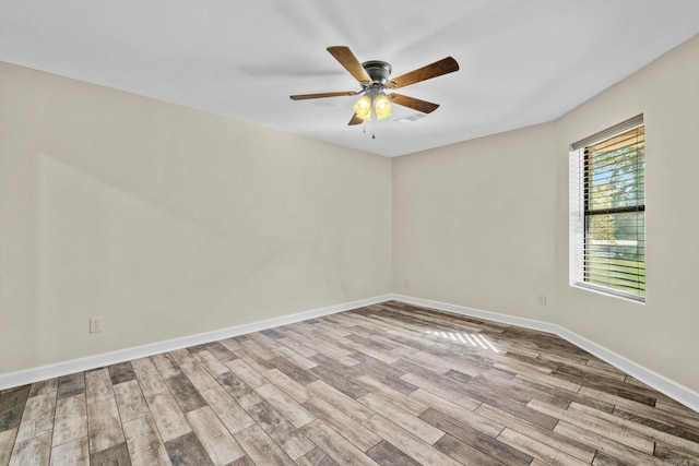 spare room with light wood-type flooring and ceiling fan