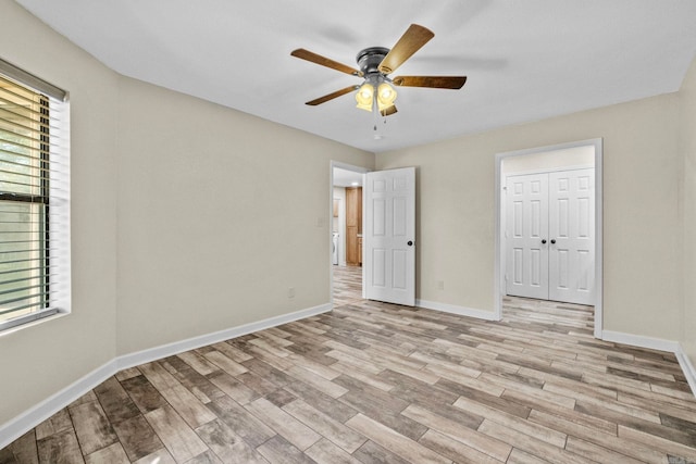 unfurnished bedroom featuring ceiling fan, light hardwood / wood-style flooring, and a closet