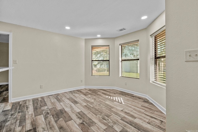 spare room with light hardwood / wood-style flooring