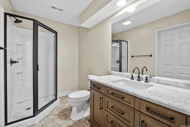 bathroom with tile patterned floors, vanity, toilet, and walk in shower