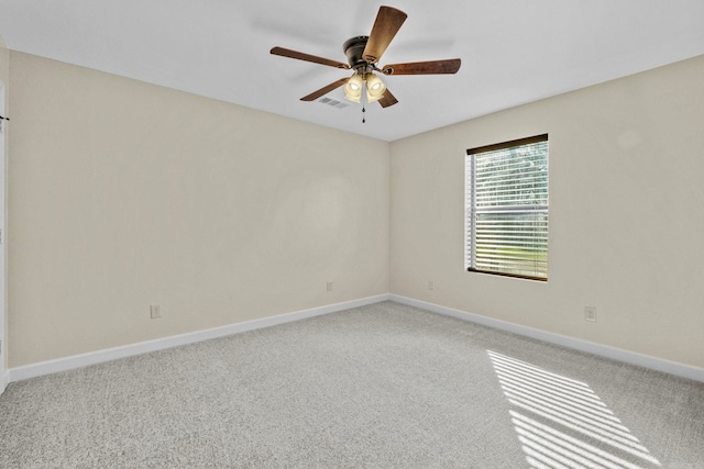 spare room featuring ceiling fan and carpet floors