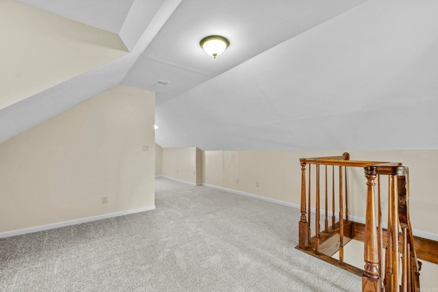 bonus room featuring light colored carpet and lofted ceiling