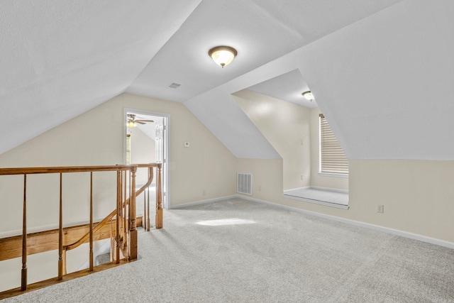 bonus room featuring ceiling fan, carpet, and vaulted ceiling