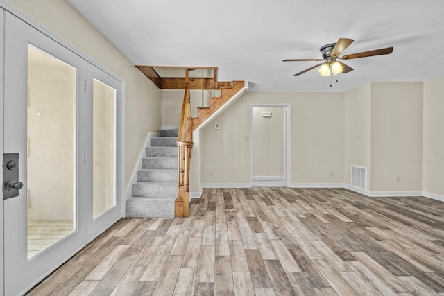 interior space with ceiling fan and light hardwood / wood-style floors