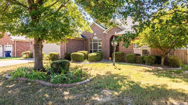 view of front of house featuring a garage and a front lawn