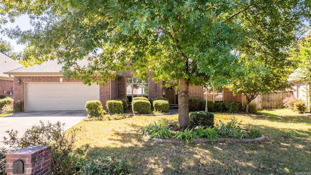 obstructed view of property with a front lawn and a garage