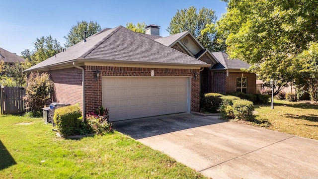 view of front of property with a garage and a front lawn