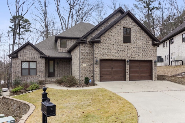 view of front of property featuring central AC, a front yard, and a garage