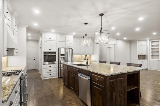 kitchen featuring sink, white cabinetry, a kitchen island with sink, and appliances with stainless steel finishes