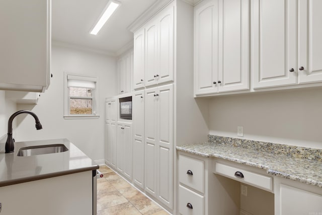 laundry area featuring crown molding and sink