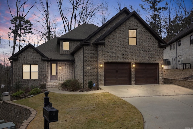 view of front facade with a lawn and a garage