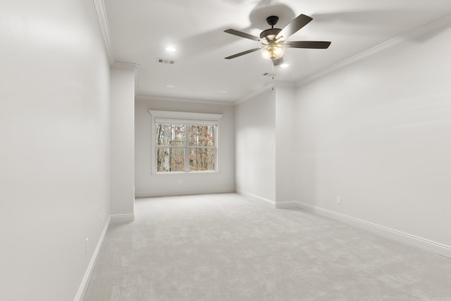 unfurnished room with light carpet, ceiling fan, and ornamental molding