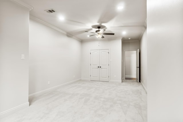 carpeted empty room featuring ceiling fan and ornamental molding