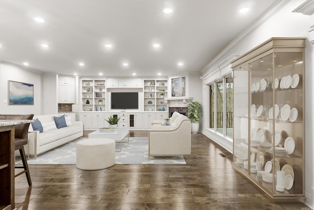 living room with dark hardwood / wood-style floors and ornamental molding