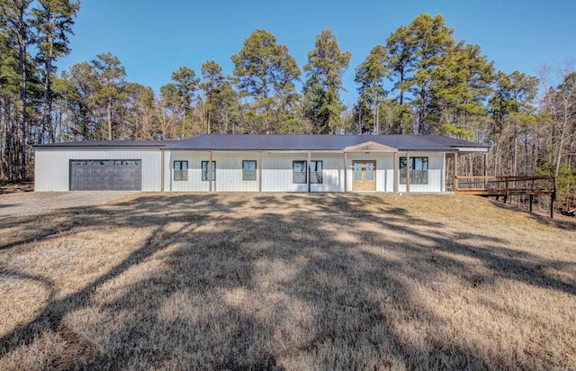 ranch-style home with a garage and a front lawn