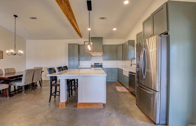 kitchen with a center island, concrete floors, decorative light fixtures, a breakfast bar, and appliances with stainless steel finishes