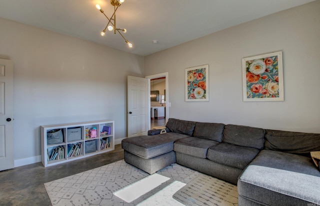 living room with concrete floors and a notable chandelier