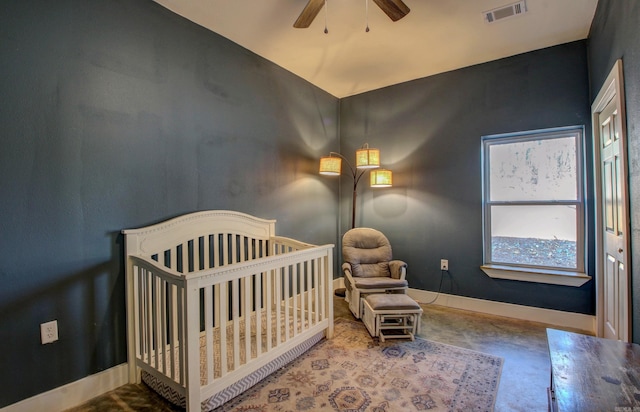 bedroom with ceiling fan and a crib