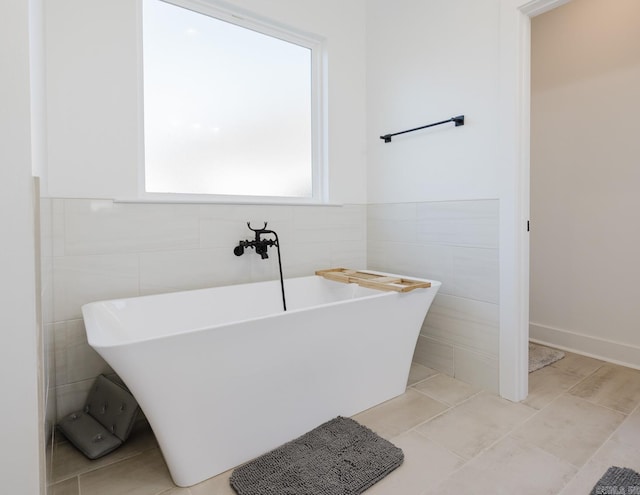 bathroom featuring tile walls and a bathing tub