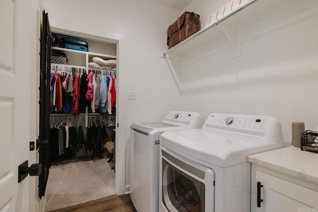 laundry area featuring washer and dryer and dark hardwood / wood-style floors