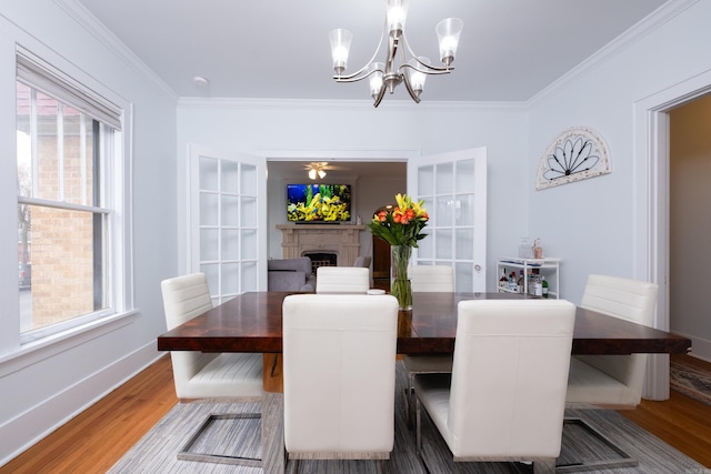 dining space featuring plenty of natural light, ornamental molding, and dark hardwood / wood-style floors