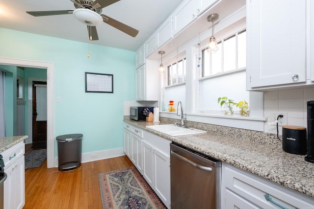 kitchen with appliances with stainless steel finishes, sink, and white cabinetry