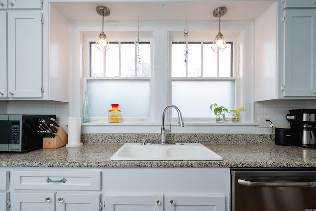 kitchen featuring decorative backsplash, sink, white cabinetry, and stainless steel appliances