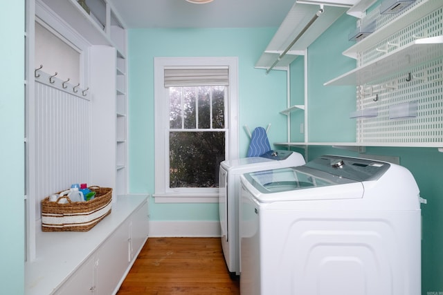 laundry room featuring washing machine and dryer and hardwood / wood-style floors