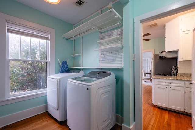 washroom with ceiling fan, separate washer and dryer, and light hardwood / wood-style floors