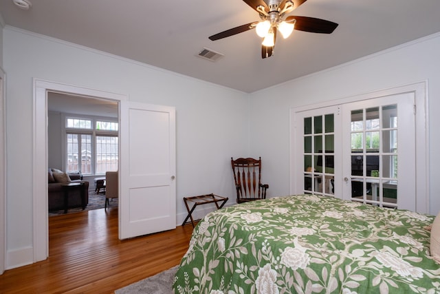 bedroom featuring ceiling fan, crown molding, and hardwood / wood-style floors