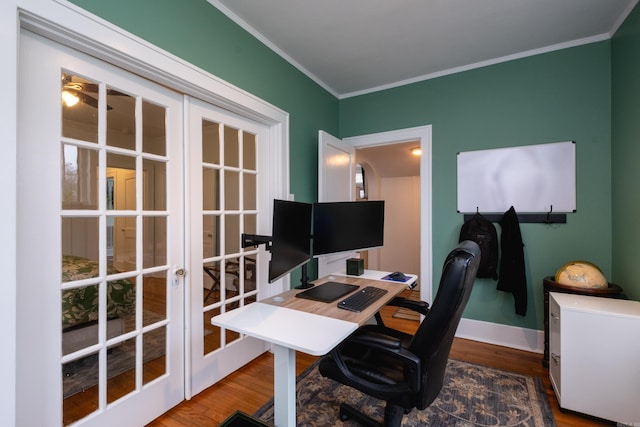 office with hardwood / wood-style flooring, ornamental molding, and french doors