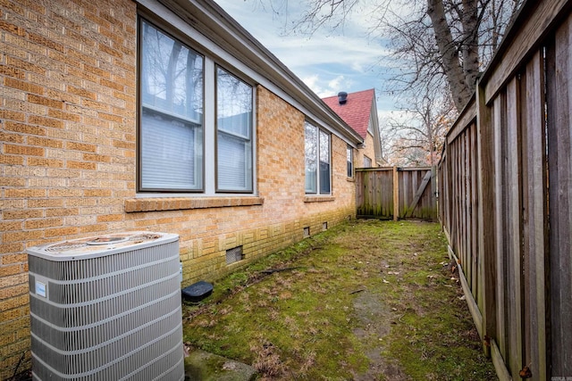 view of side of home with central AC