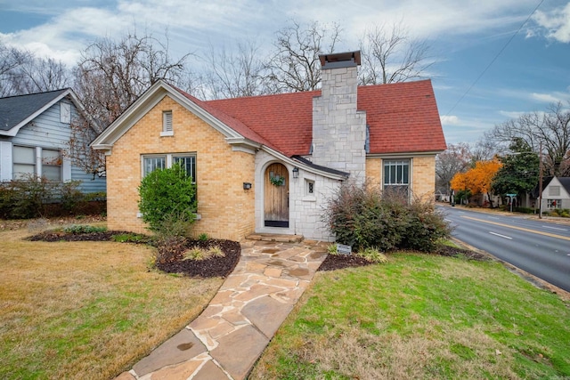 tudor-style house with a front yard