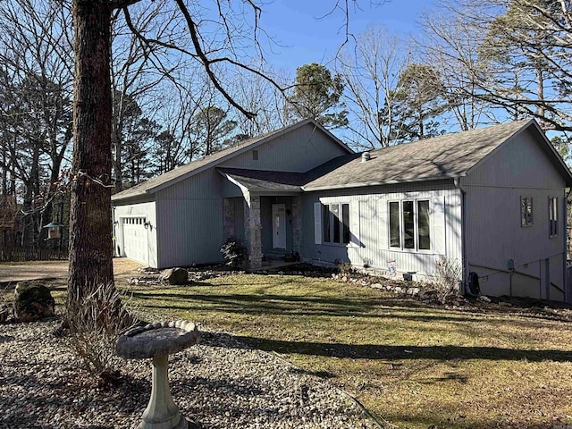 view of front of house featuring a front yard and a garage