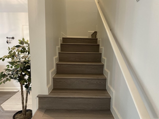 stairs with hardwood / wood-style flooring