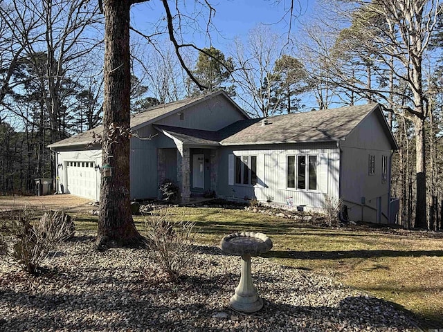 view of front of property with a garage and a front lawn